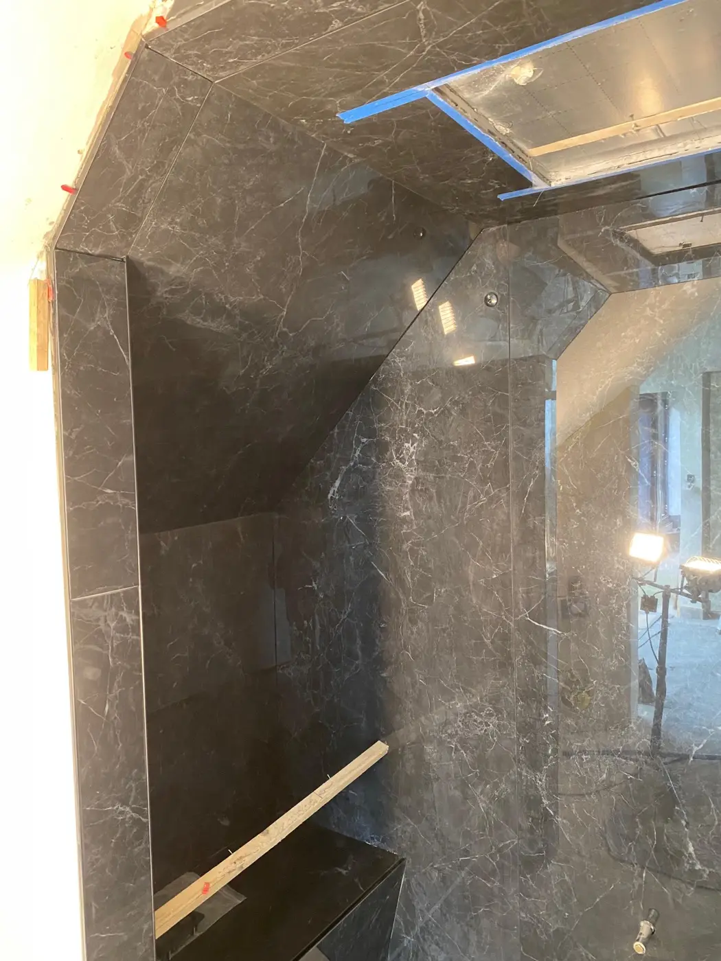 Black marble wet room tiling with full-height tiles to vaulted ceiling, specialist tiler in Bromley and South East London