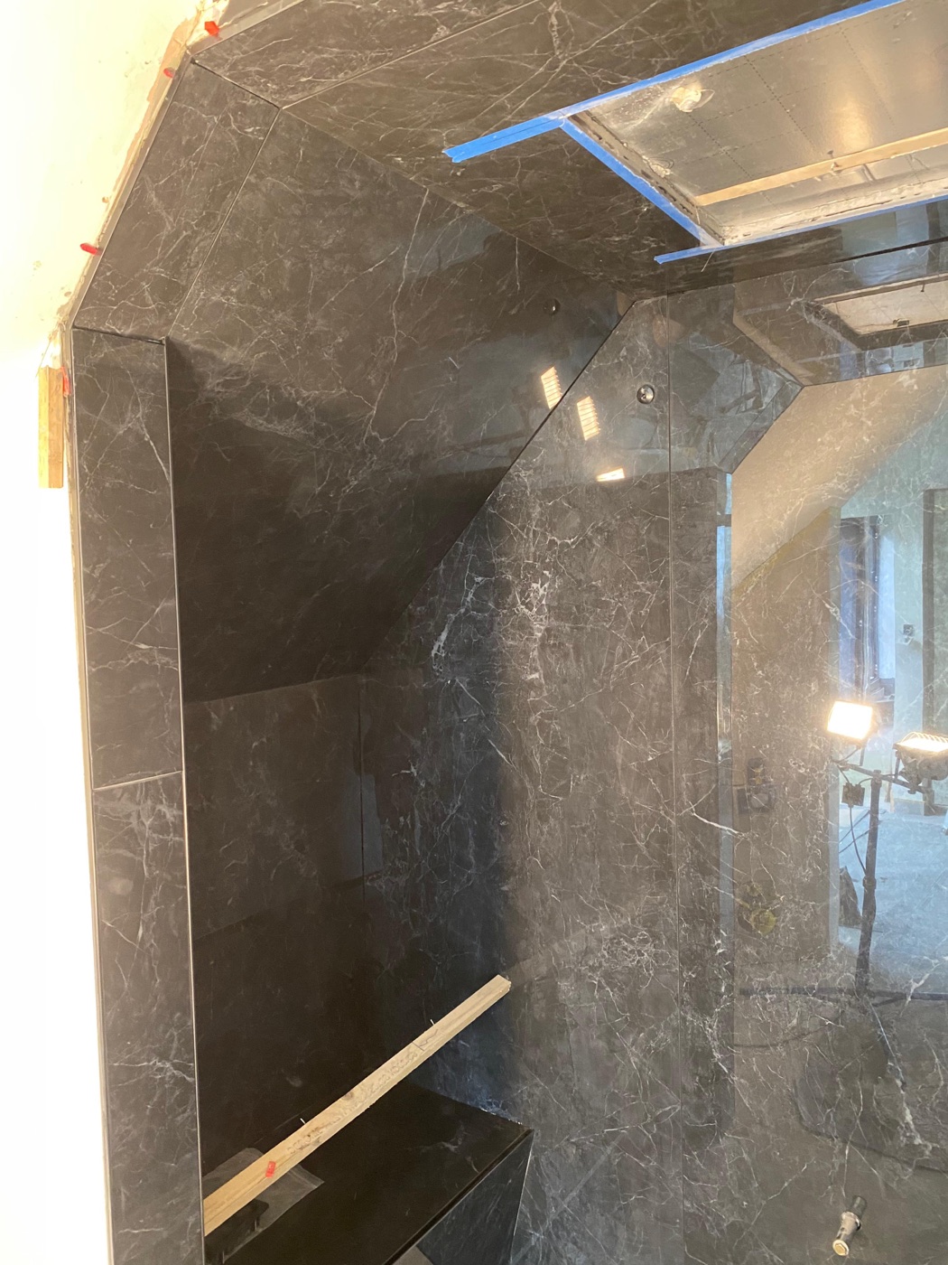 Black marble wet room tiling with full-height tiles to vaulted ceiling, West Wickham — Bromley Tiler
