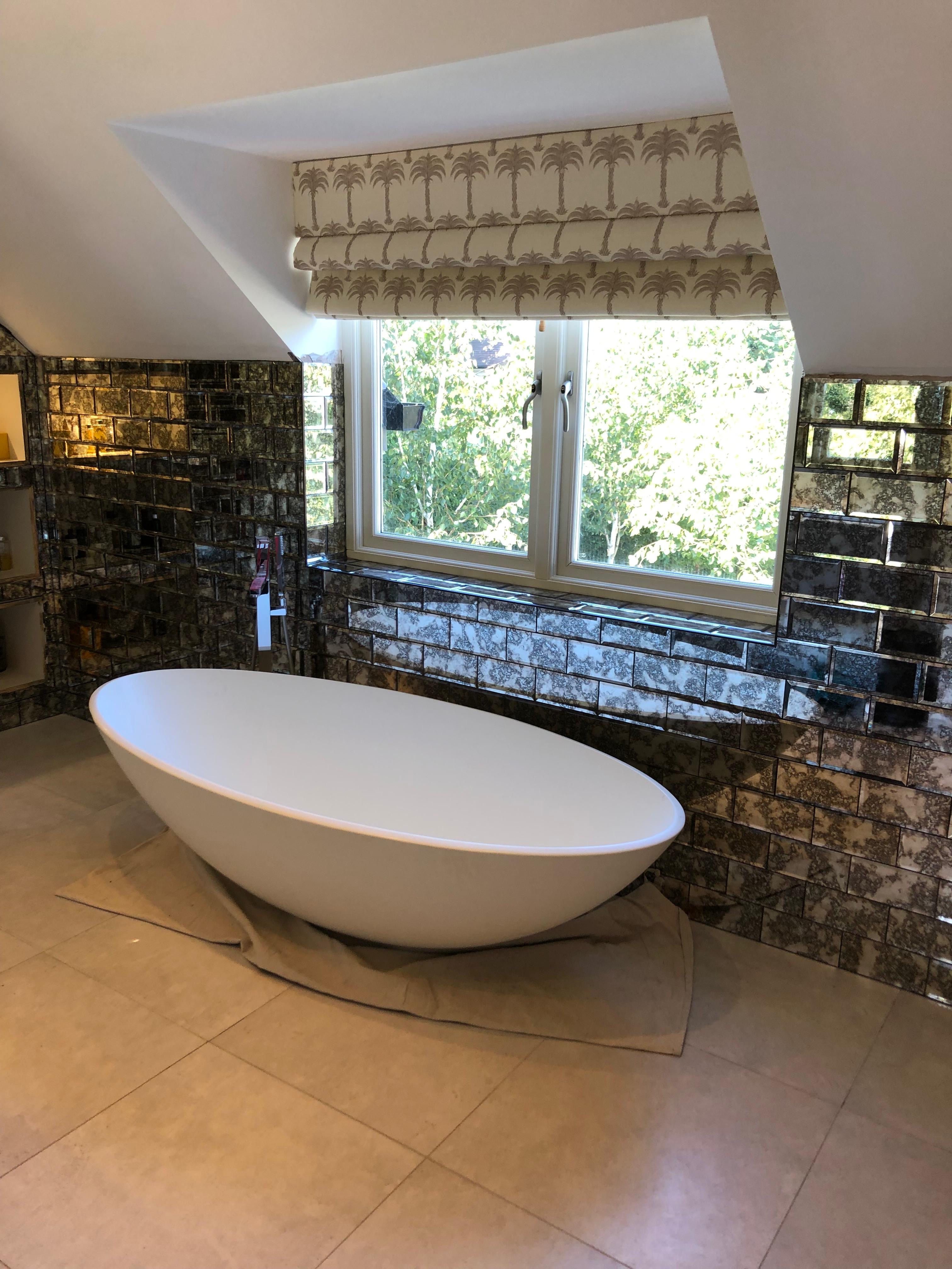 Bathroom Tiling in Orpington — Luxury bathroom with antique mirror brick tiles and freestanding oval bath, Bromley — Bromley Tiler