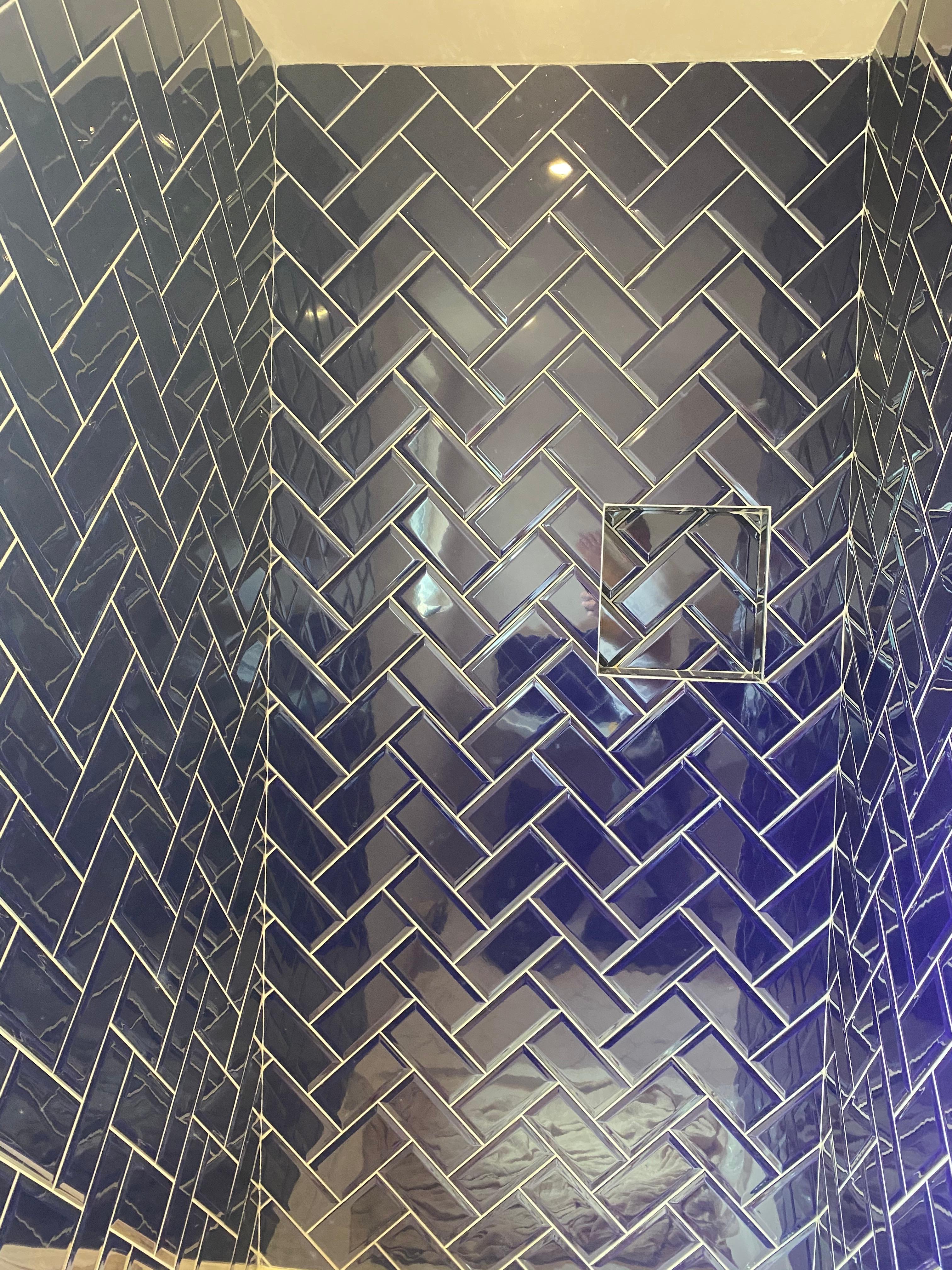 Navy herringbone shower wall with crisp, freshly finished grout lines, Bromley, Bromley Tiler
