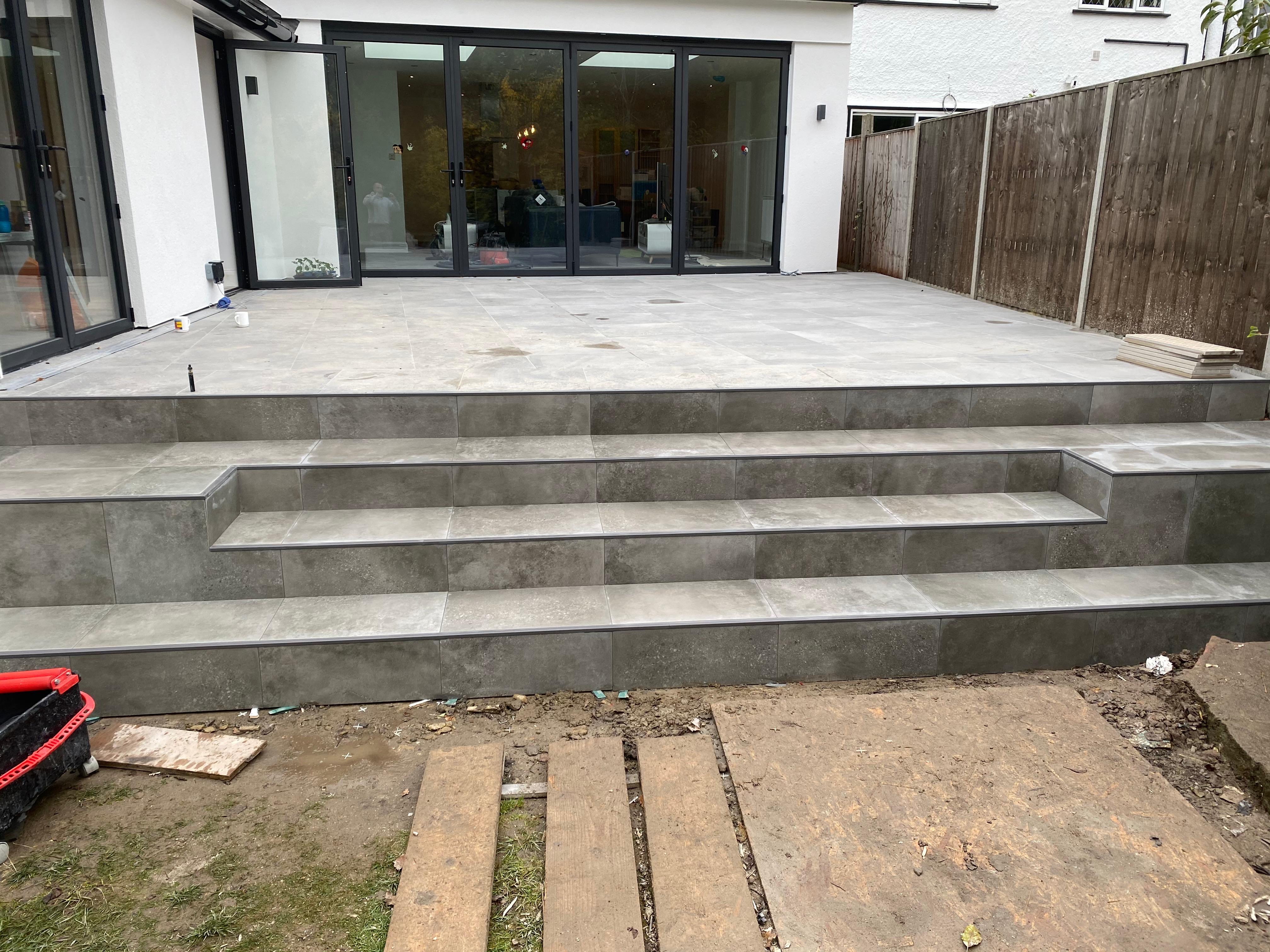 Finished frost-proof porcelain patio with tiled steps in a Sevenoaks garden, South East London